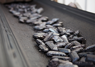 Hot briquetted iron on conveyor belt